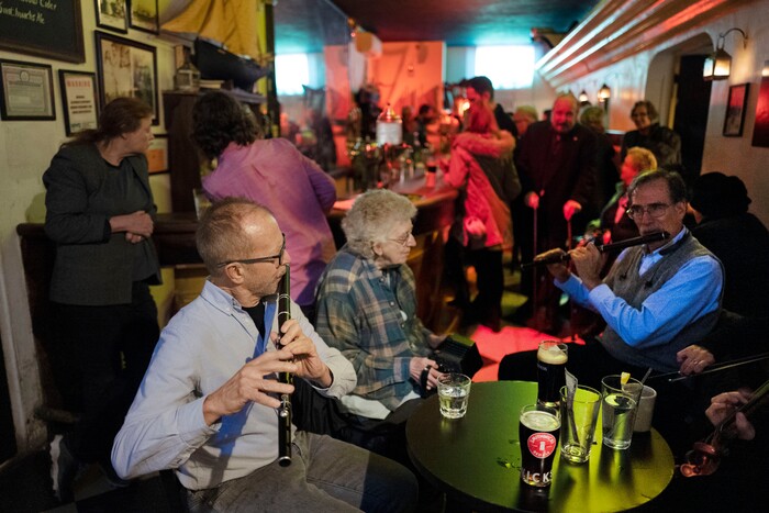 In this Dec. 31, 2019 photo, Richard Heitzman joins with fellow musicians to perform traditional Irish tunes in New York's William Barnacle Tavern, once a speakeasy during Prohibition. Americans are consuming more alcohol per capita now than in the time leading up to Prohibition, when alcohol opponents successfully made the case that excessive drinking was ruining family life. (AP Photo/Mark Lennihan)
