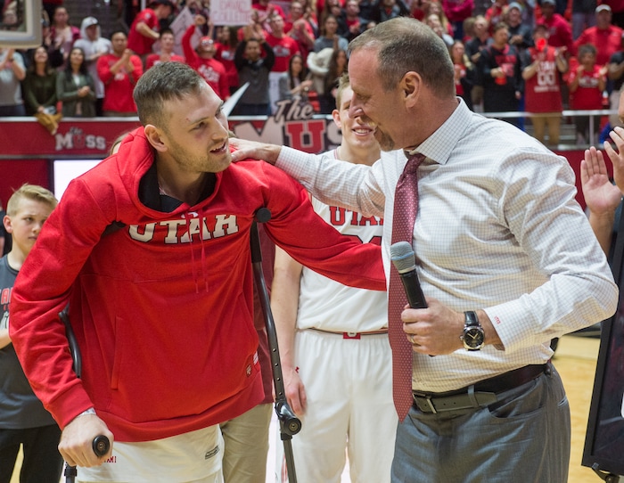 (Rick Egan  |  The Salt Lake Tribune)  Utah Utes head coach Larry Krystkowiak hugs Utah Utes forward David Collette as he makes it back out on to the court to be honored on senior night.  Collette was injured earlier in the game, in PAC-12 basketball action between Utah Utes and Colorado Buffaloes, at the Jon M. Huntsman Center, Saturday, March 3, 2018.