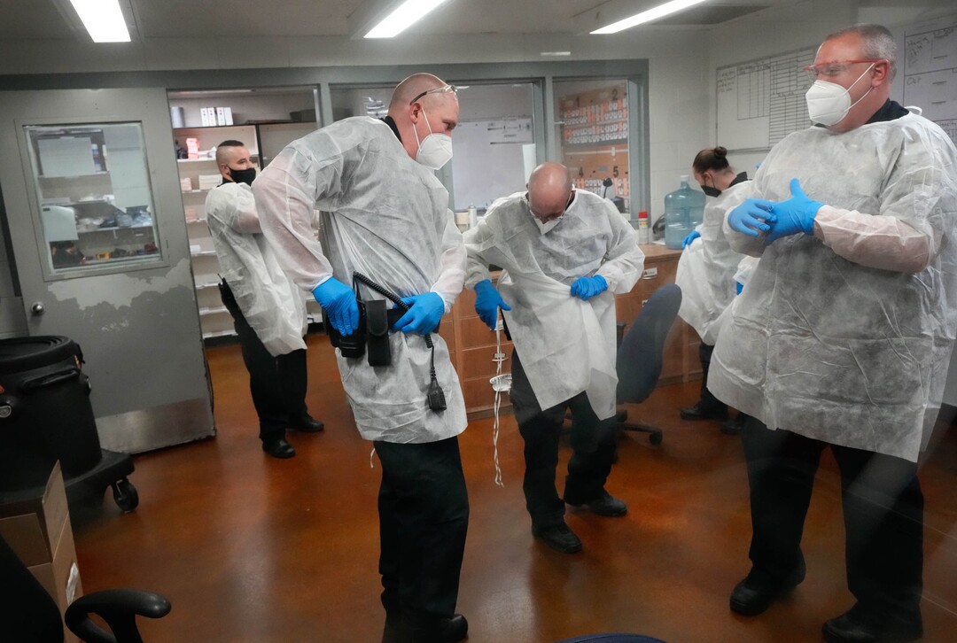 (Francisco Kjolseth | The Salt Lake Tribune) Prison guards suit up in PPE gear at the Utah State Prison in Draper on Tuesday, July 27, 2021, before a vaccination event with incoming inmates who want the COVID-19 vaccine.