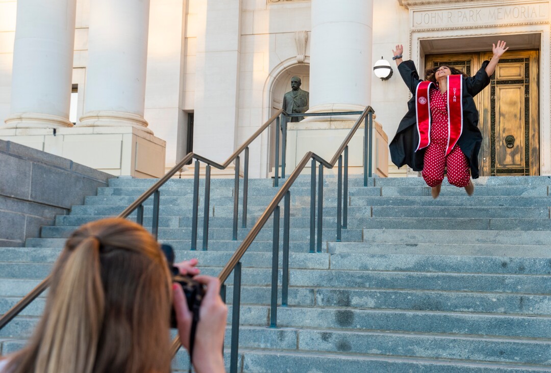 (Rick Egan  |  The Salt Lake Tribune)    Melissa Brewster leaps in the air for a graduation picture in front of the Park Building at the University of Utah, Thursday April 30, 2020