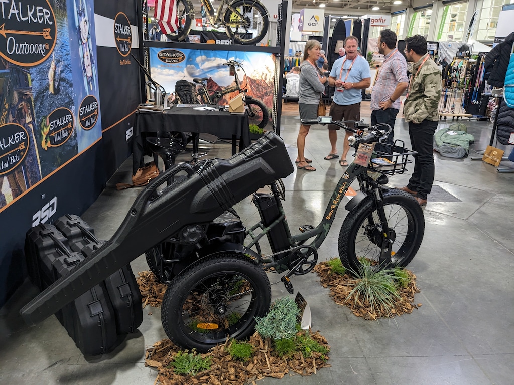 (Julie Jag | The Salt Lake Tribune) The Arpenter off-road tricycle was front and center at the Stalker Outdoor booth at the Outdoor Retailer trade show in the Salt Palace Convention Center on Tuesday, June 21, 2023. Cofounder Andrew Mochkovitch, who has based the company in Ogden where he lives, is at right.