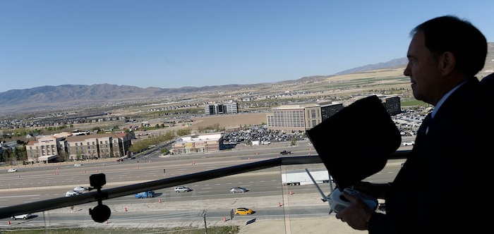 (Al Hartmann | The Salt Lake Tribune)
Gov. Gary R. Herbert uses remote control to pilot a drone in Lehi Wednesday April 25 to get a view of the Utah Department of Transportation’s (UDOT) I-15 Tech Corridor project in Lehi for a pre-construction site tour. The project will widen I-15 with two new lanes in each direction from Lehi Main Street to S.R. 92. It will also alleviate east-west congestion in this busy area by building a bridge at Triumph Boulevard, adding a one-way frontage road system from 2100 North to S.R. 92 and reconstructing those two interchanges. In addition, the project will construct 17 bridges and include several bike and pedestrian improvements.