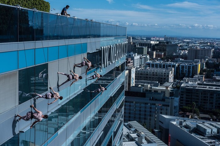 (Photo courtesy of Basil Tsimoyianis) Oakland, Calif.-based “vertical dance” company BANDALOOP performs with pop star P!nk on the JW Marriott building in Los Angeles at the 2017 American Music Awards. BANDALOOP will be appearing at the Utah Arts Festival June 21-24, and will perform twice daily (5:30 and 7 p.m.) on the six-story library glass wall above the reflecting pool.