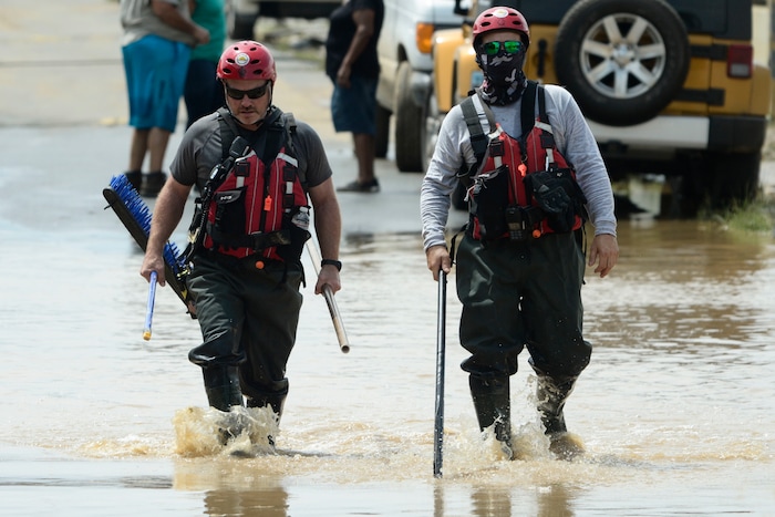 Personnel from a FEMA search and rescue crew walk in a flooded road, after the passing of Hurricane Maria, in Toa Baja, Puerto Rico, Friday, September 22, 2017. Because of the heavy rains brought by Maria, thousands of people were evacuated from Toa Baja after the municipal government opened the gates of the Rio La Plata Dam. (AP Photo/Carlos Giusti)