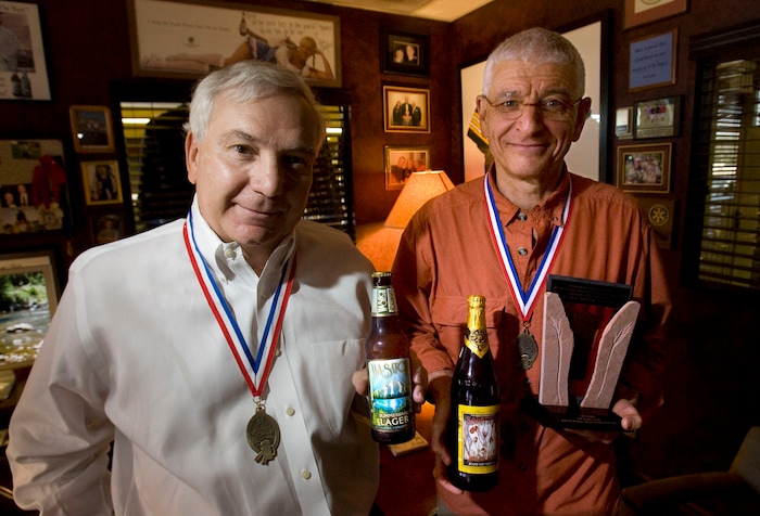 (Steve Griffin | Tribune file photo) Wasatch Beers managing partner Greg Schirf and Squatters founder Peter Cole with first place medals and top prize trophy for Mid-Size Brewing Company and Mid-Size Brewing Company Brewer of the Year at the Great American Beer Festival in September 2010. Utah Brewers Cooperative also won gold medals for Summerbrau and Squatter's Wit as well as a bronze for Hell's Keep.