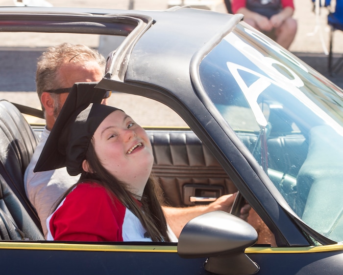 (Rick Egan  |  The Salt Lake Tribune)     Alta High senior Abby, smiles as she rides in the parade of 2020 graduates in a “drive through” graduation ceremony at Alta High, Thursday, May 28, 2020.
