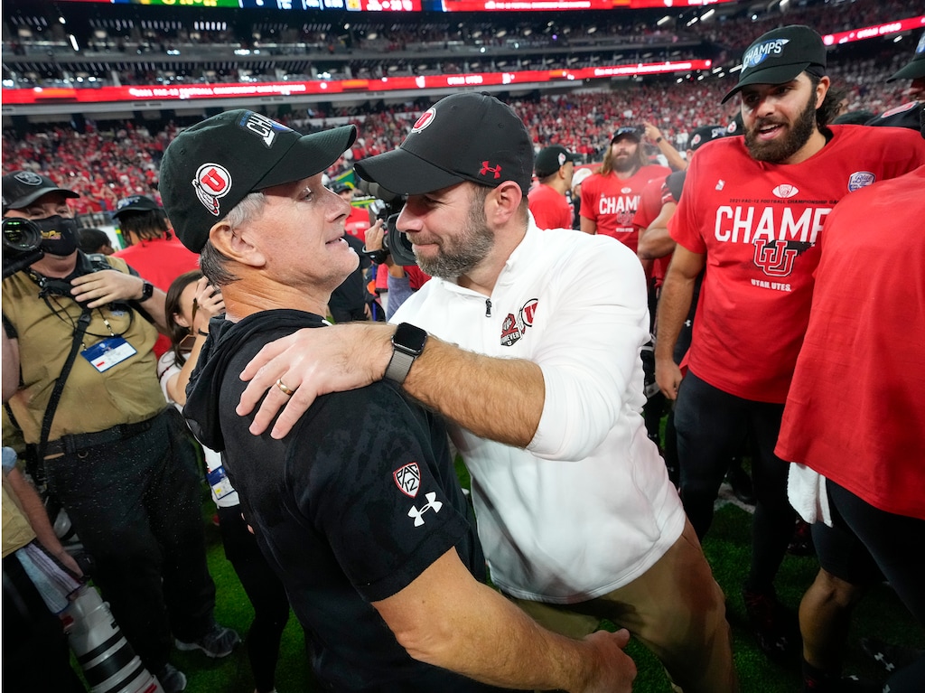 (Leah Hogsten | The Salt Lake Tribune) Kyle Whittingham and Morgan Scalley celebrate together after Utah wins the Pac-12 title.