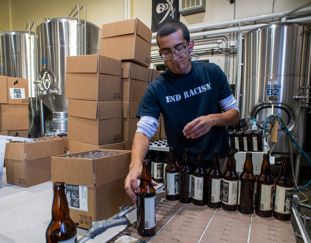 (Rick Egan  |  The Salt Lake Tribune)    Jordan Vigil loads bottles in the brewery at Epic Brewing Co. in Salt Lake City, Thursday, Oct. 29, 2020.