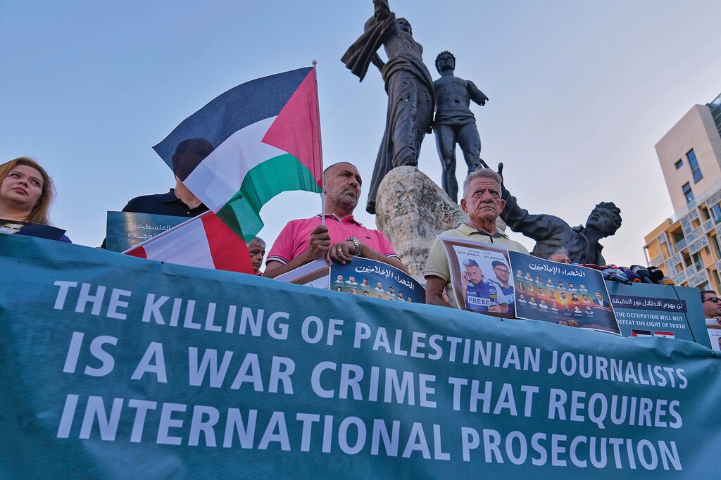 Lebanese and Palestinian journalists hold photos of journalists who killed by Israeli forces in Gaza and Lebanon during a protest at the Martyrs square in downtown Beirut, Monday, Sept. 1, 2025. (AP Photo/Hussein Malla)
