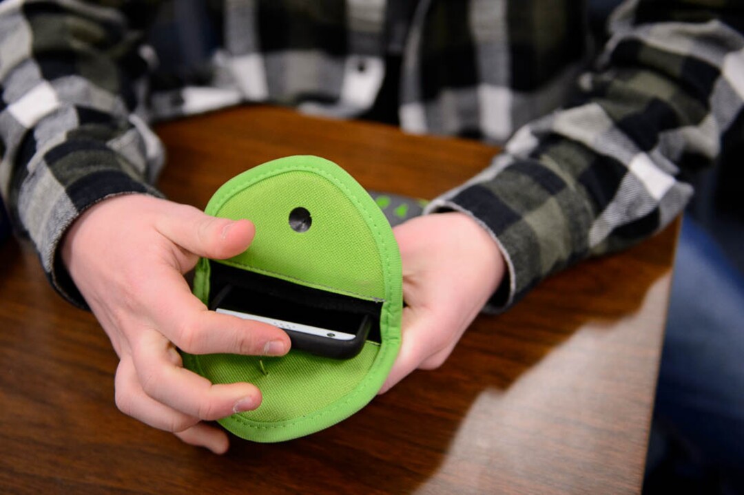 (Trent Nelson | The Salt Lake Tribune) Students in Monta Thomas' classes at Brighton High School in Cottonwood Heights secure their phones in locking pouches made by Yondr.