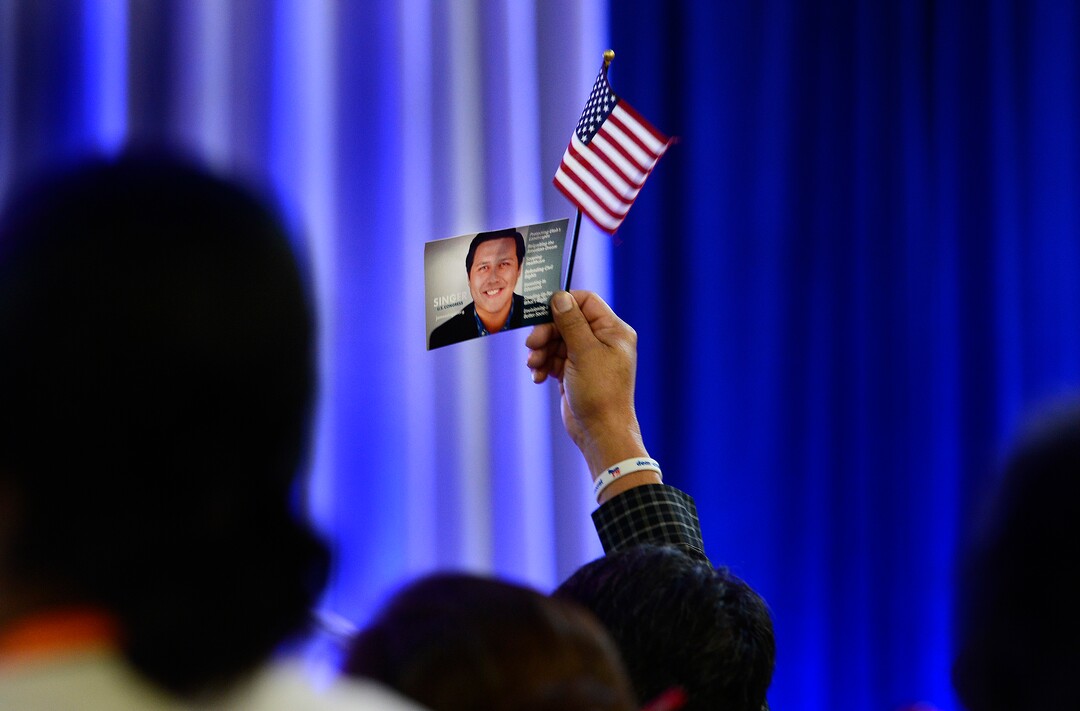 (Scott Sommerdorf | The Salt Lake Tribune)
A supporter holds up a flag and a James Singer card as Singer speaks at the Democratic convention, Saturday, April 28, 2018 at the Salt Palace Convention Center in Salt Lake City, Utah.
