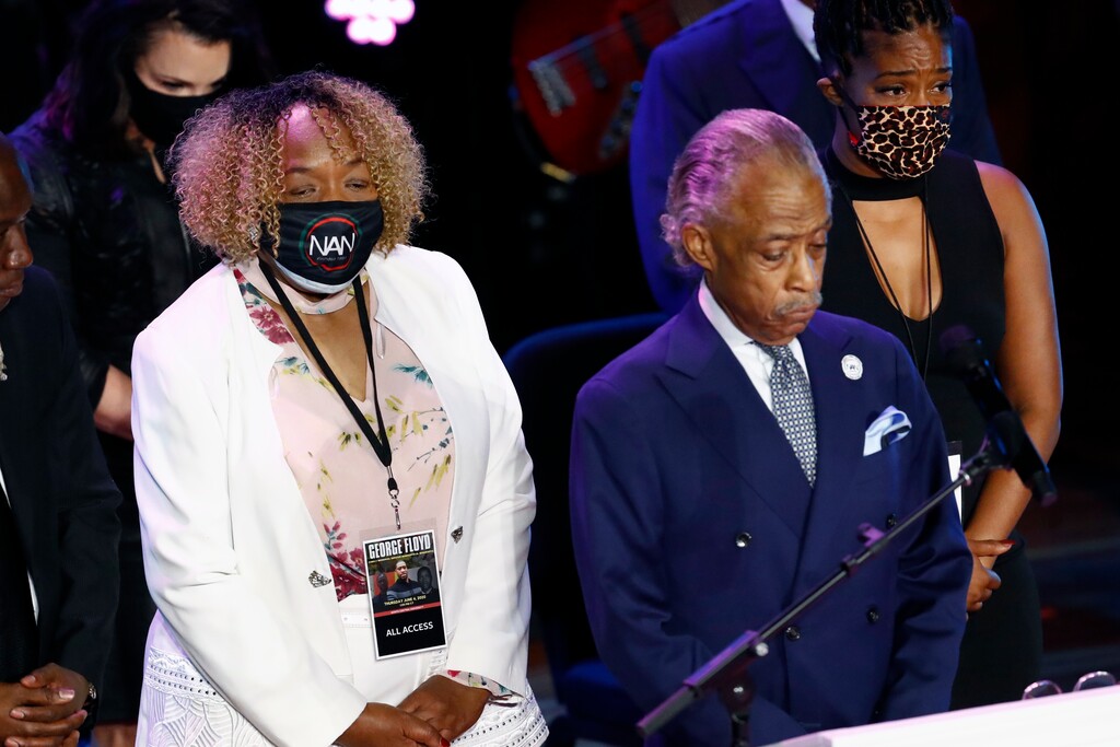 (Julio Cortez | AP) Eric Garner's mother, Gwen Carr left, joins the Rev. Al Sharpton, center and entertainer Tiffany Haddish left on stage for 8 minutes, 46 seconds of silence during a memorial service for George Floyd at North Central University Thursday, June 4, 2020, in Minneapolis.
