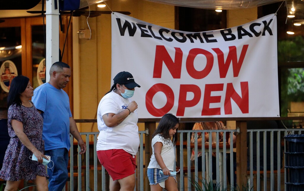 (AP Photo/Eric Gay)

Visitors to the River Walk pass a restaurant that has reopened in San Antonio, May 27.