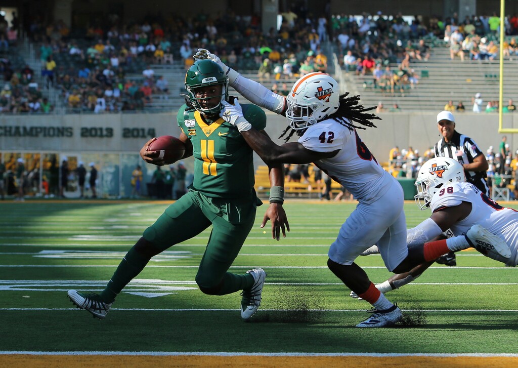 Baylor quarterback Gerry Bohanon, left, scores past UTSA linebacker Ladarian McFarland, right, in the second half of an NCAA college football game, Saturday, Sept. 7, 2019, in Waco, Texas. (Jose Yau/Waco Tribune-Herald via AP)