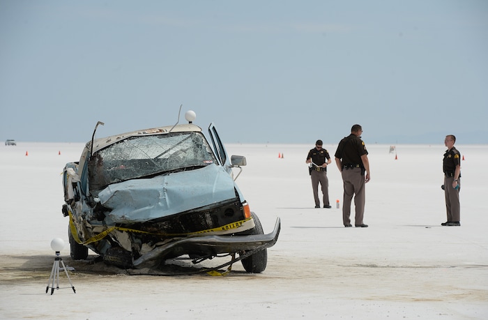 (Francisco Kjolseth | The Salt Lake Tribune) Highway patrol investigate the scene of a deadly crash at Utah's Bonneville Salt Flats along the sidelines of Speed Week following a head-on collision between two vehicles carrying support crew traveling between the pits and the entrance to the salt along the access road on Wednesday, Aug. 16, 2017. One person was killed and five injured, all of whom were said to be members of support crews for racing drivers.