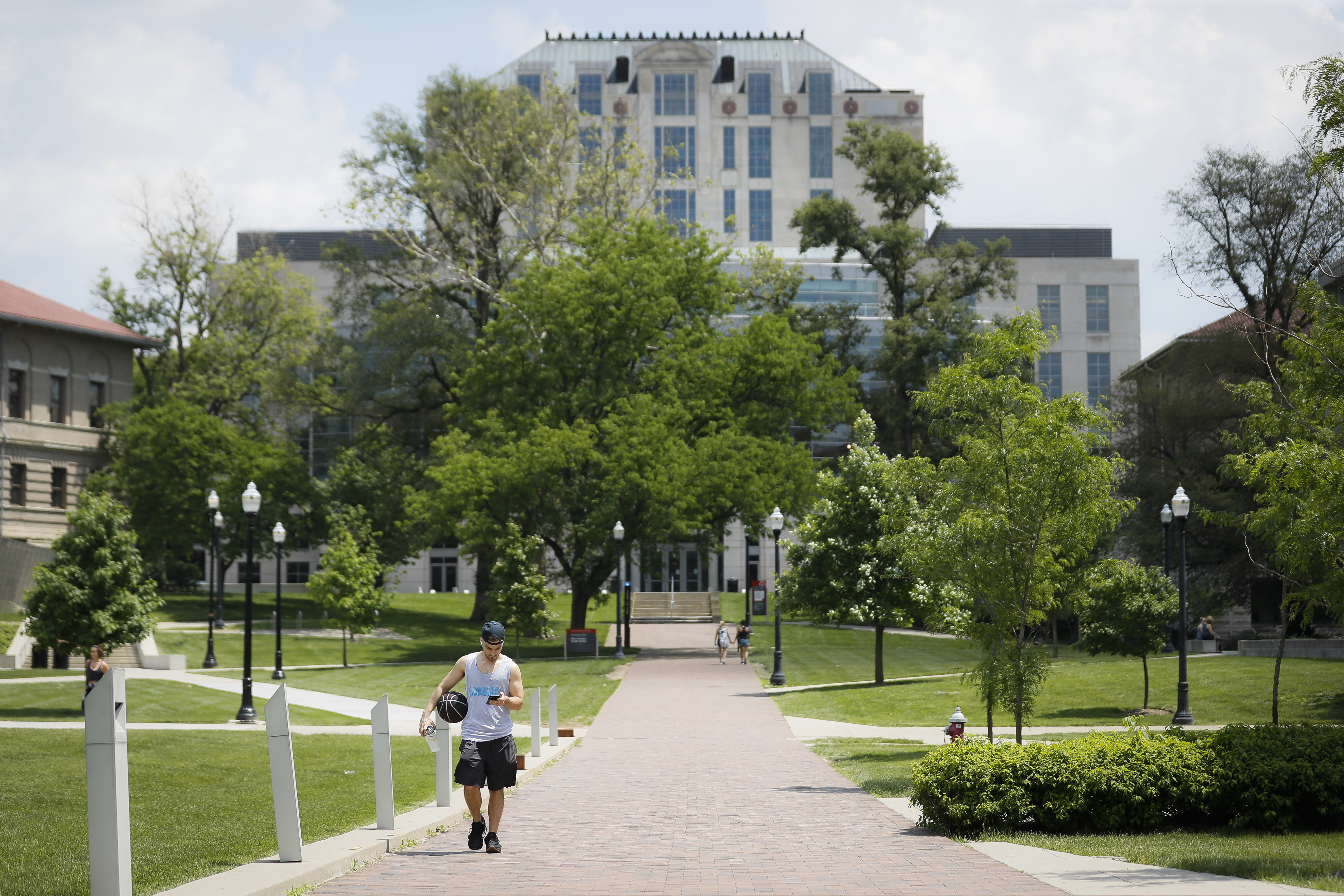 (John Minchillo | AP) Pedestrians walk towards The Ohio State University's athletics facilities, Saturday, May 18, 2019, in Columbus, Ohio. Dr. Richard Strauss, a now-dead Ohio State team doctor sexually abused at least 177 male students from the 1970s through the 1990s, and numerous university officials got wind of what was going on over the years but did little or nothing to stop him, according to a report released by the school Friday.