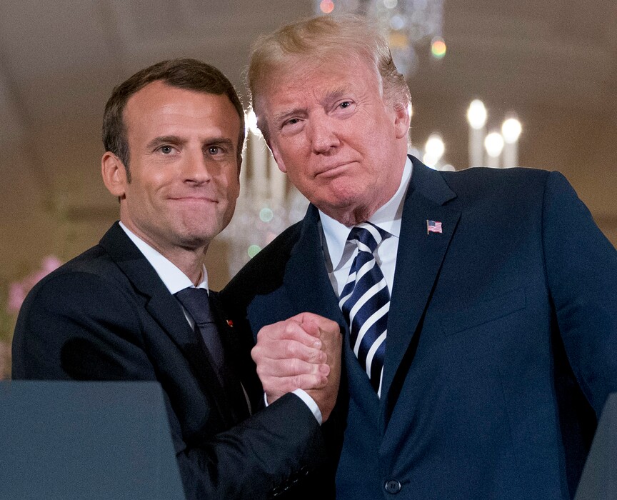 President Donald Trump and French President Emmanuel Macron embrace at the conclusion of a news conference in the East Room of the White House in Washington, Tuesday, April 24, 2018. (AP Photo/Andrew Harnik)