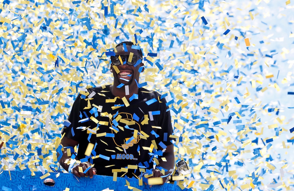Confetti comes down on Golden State Warriors' Draymond Green (23) is surrounded by confetti during the team's NBA basketball championship parade, Tuesday, June 12, 2018, in Oakland, Calif. (AP Photo/Tony Avelar)