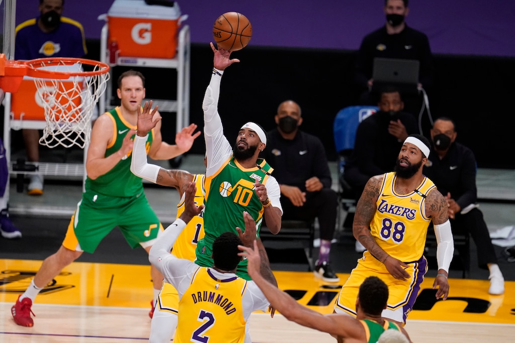 Utah Jazz guard Mike Conley (10) shoots over Los Angeles Lakers center Andre Drummond (2) during the first half of an NBA basketball game Monday, April 19, 2021, in Los Angeles. (AP Photo/Marcio Jose Sanchez)