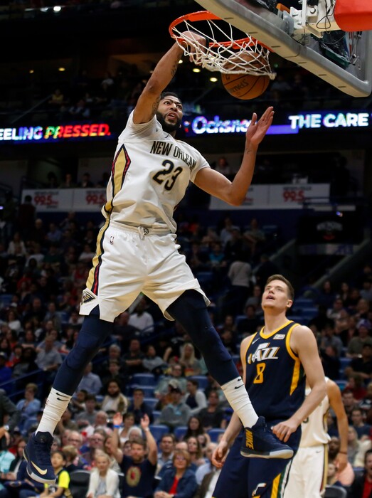 New Orleans Pelicans forward Anthony Davis (23) dunks as Utah Jazz forward Jonas Jerebko (8) trails the play in the first half of an NBA basketball game in New Orleans, Sunday, March 11, 2018. (AP Photo/Scott Threlkeld)