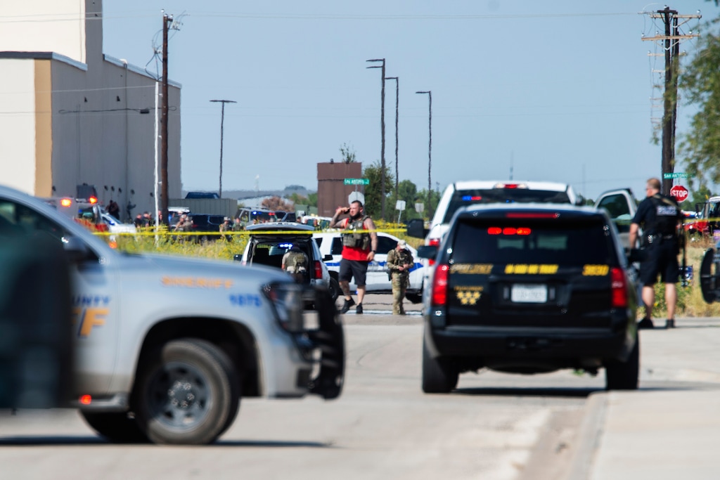 (Tim Fischer | Midland Reporter-Telegram via AP) Odessa and Midland police and sheriff's deputies surround the area behind Cinergy in Odessa, Texas, Saturday, Aug. 31, 2019, after reports of shootings. Police said there are "multiple gunshot victims" in West Texas after reports of gunfire on Saturday in the area of Midland and Odessa.