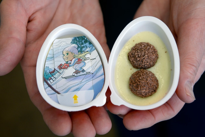 (Al Hartmann  |  The Salt Lake Tribune) Sharon Wuolukka, owner of the Dutch Store in Salt Lake City, holds a box of Kinder Joy eggs, a popular European treat is available for the first time in the U.S. this Christmas. The FDA had previously banned the candy, saying it was a potential choking hazard because a toy was hidden inside the chocolate. The new American version of the eggs, called “Kinder Joy,” have two halves — one with a toy and the other with pure chocolate.  They are flying off the shelves at Utah specialty shops like the Dutch Store.