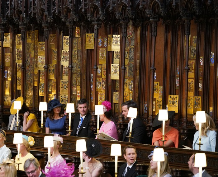From left, George Clooney, Amal Clooney, Silver Tree, Abraham Levy, Celine Khavarani, Markus Anderson, Janina Gavankar, and Jill Smoller are seated prior to the start of the wedding ceremony of Prince Harry and Meghan Markle at St. George's Chapel in Windsor Castle in Windsor, near London, England, Saturday, May 19, 2018. (Dominic Lipinski/pool photo via AP)
