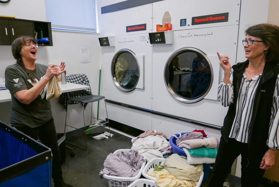 (Clara Hatcher | The Salt Lake Tribune) Dolores "Dee" Buchanan (left) laughs while her friend and fellow volunteer, Kathy Wagner, explains what the two talk about to pass the time while working.