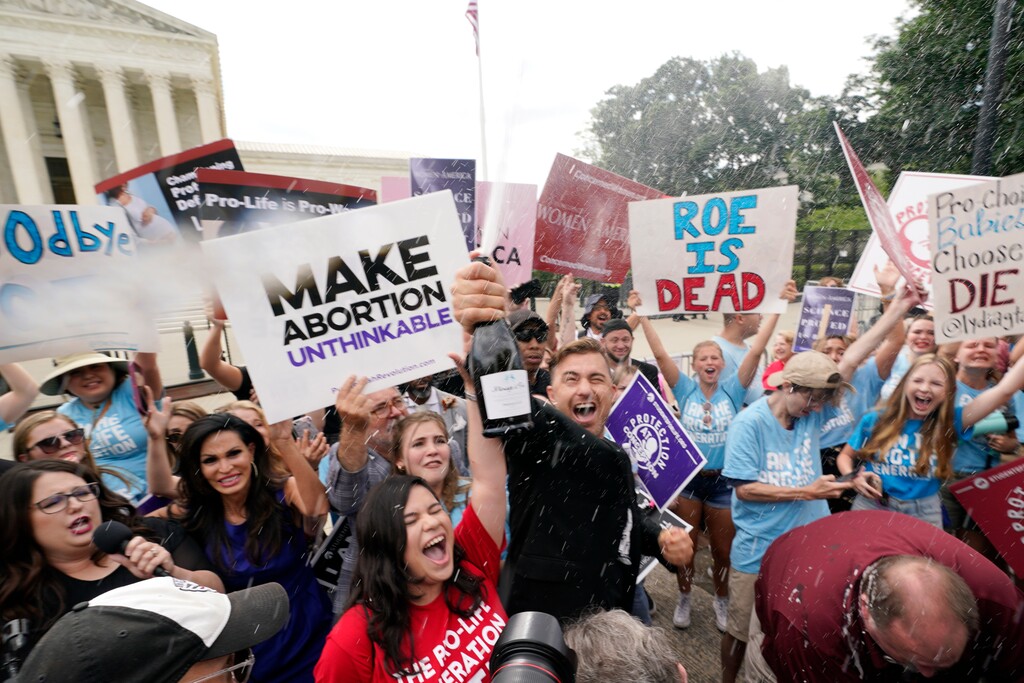 (Steve Helber | AP) A celebration outside the Supreme Court, Friday, June 24, 2022, in Washington. The Supreme Court has ended constitutional protections for abortion that had been in place nearly 50 years — a decision by its conservative majority to overturn the court's landmark abortion cases.