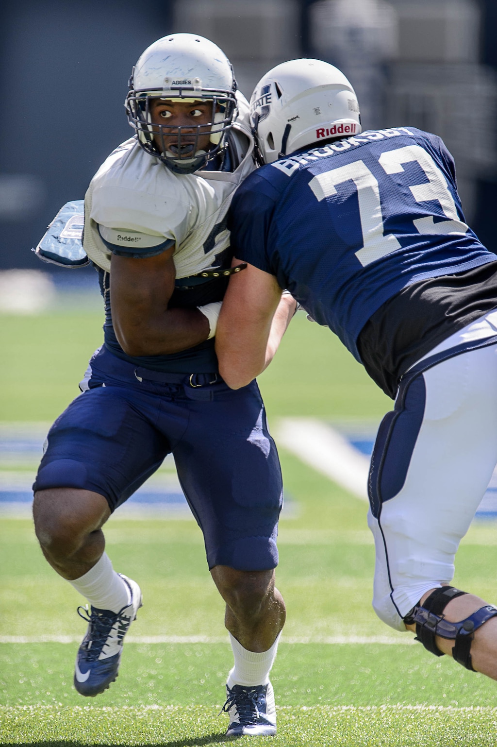 Trent Nelson  |  The Salt Lake TribuneTorrey Green collides with Garrett Gregg at the Utah State spring football game in Maverik Stadium, Logan, Saturday April 11, 2015.