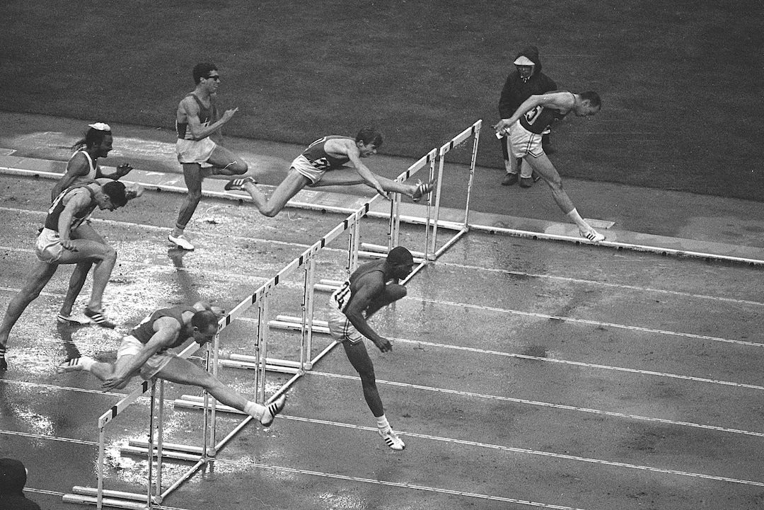 Hayes Jones of Detroit, bottom right, and Blaine Lindgren of Salt Lake City, clear the last hurdle in the 110-meter hurdle final which Jones won at the Olympic games in Tokyo, Oct. 18, 1964.  At bottom left is Russia's Anatoly Mikhailov who came in third.  At top left is Mariel Duriez of France of who ran fifth, and going over a hurdle is Edy Ottoz of Italy, who came in fourth. Lindgren died Oct. 5, 2019. Lingren was 80.  (AP Photo)