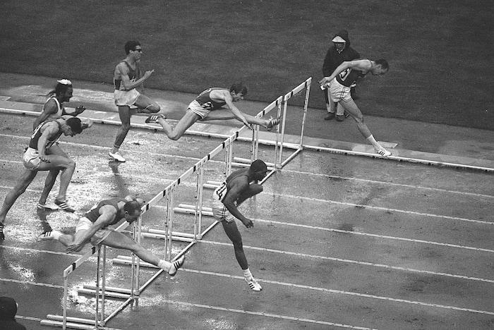 Hayes Jones of Detroit, bottom right, and Blaine Lindgren of Salt Lake City, clear the last hurdle in the 110-meter hurdle final which Jones won at the Olympic games in Tokyo, Oct. 18, 1964. At bottom left is Russia's Anatoly Mikhailov who came in third. At top left is Mariel Duriez of France of who ran fifth, and going over a hurdle is Edy Ottoz of Italy, who came in fourth. Lindgren died Oct. 5, 2019. Lingren was 80. (AP Photo)
