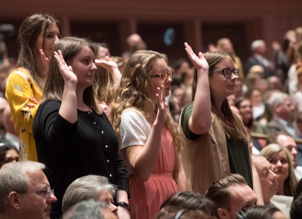 (Rick Egan  |  The Salt Lake Tribune) Young Latter-day Saint women, stand to sustain church President Russell M. Nelson in 2018. A blogger is suggesting church assignments now filled only by men and boys that could be performed by women and girls.