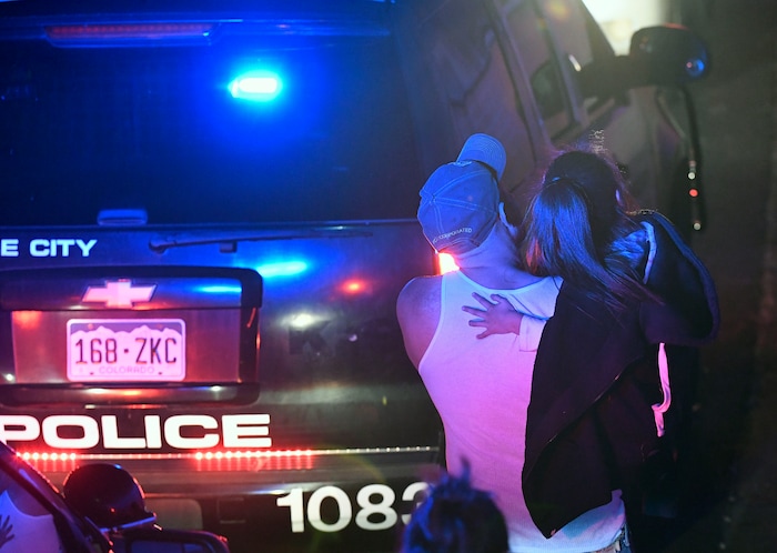A father and his scared daughter, who were customers inside Walmart, are escorted out of the parking lot and away from the scene of the Walmart store where a shooting occurred inside the store, Wednesday, Nov. 1, 2017, in Thornton, Colo. Thornton police tweeted Wednesday night that they were responding to a shooting with "multiple parties down." They advised people to stay away from the area as dozens of police cruisers and emergency vehicles raced to the scene. (Helen H. Richardson/The Denver Post via AP)