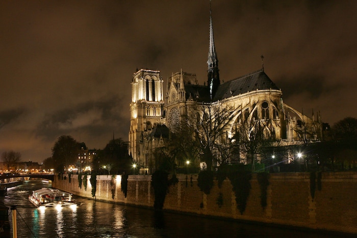 A general view of Notre-Dame de Paris Cathedral with its new lighting design, shortly after it was inaugurated by Paris mayor Bertrand Delanoe in Paris, Tuesday Dec. 12, 2006.  A river boat passes by in the Seine river below. (AP Photo/Remy de la Mauviniere)