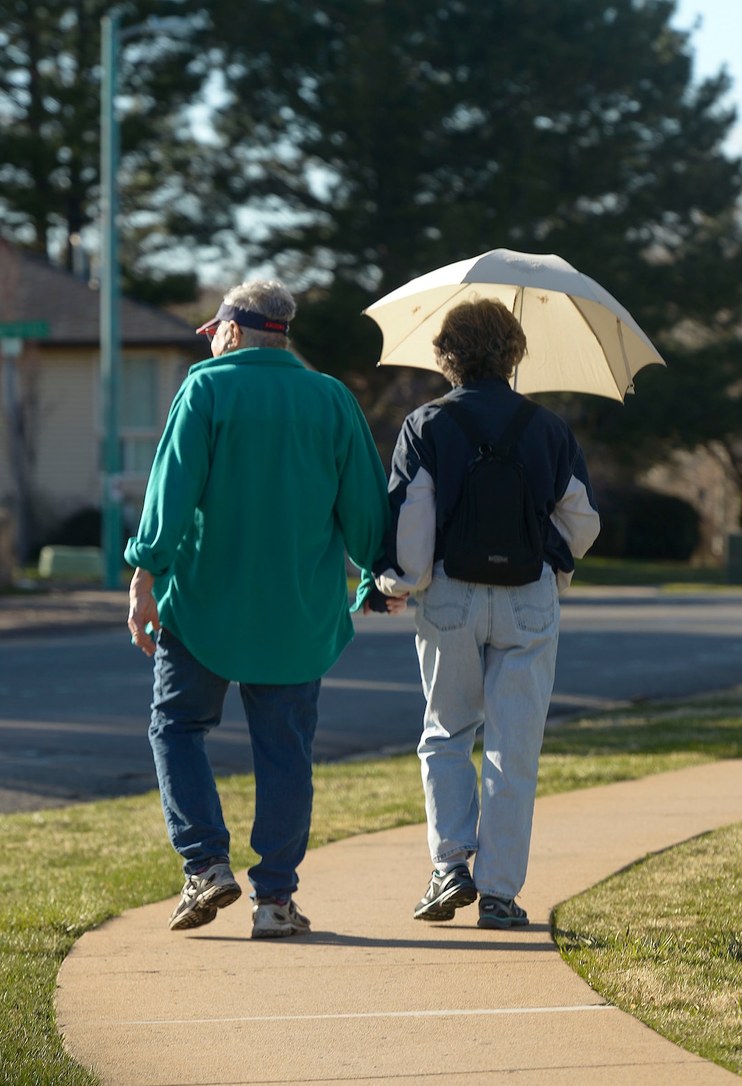 (Leah Hogsten  |  The Salt Lake Tribune) A couple walks their neighborhood in Ogden on Sunday, March 22, 2020. As the global battle against COVID-19 deepens, some Utahns have used the state's great outdoors as an alternative to isolating at home.