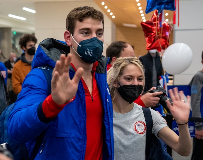 (Rick Egan | The Salt Lake Tribune) Figure skater, Brandon Frazier waves to the crowd with his aunt Heather Frazier, as he arrives at the Salt Lake City International Airport, on Monday, Feb. 21, 2022.   