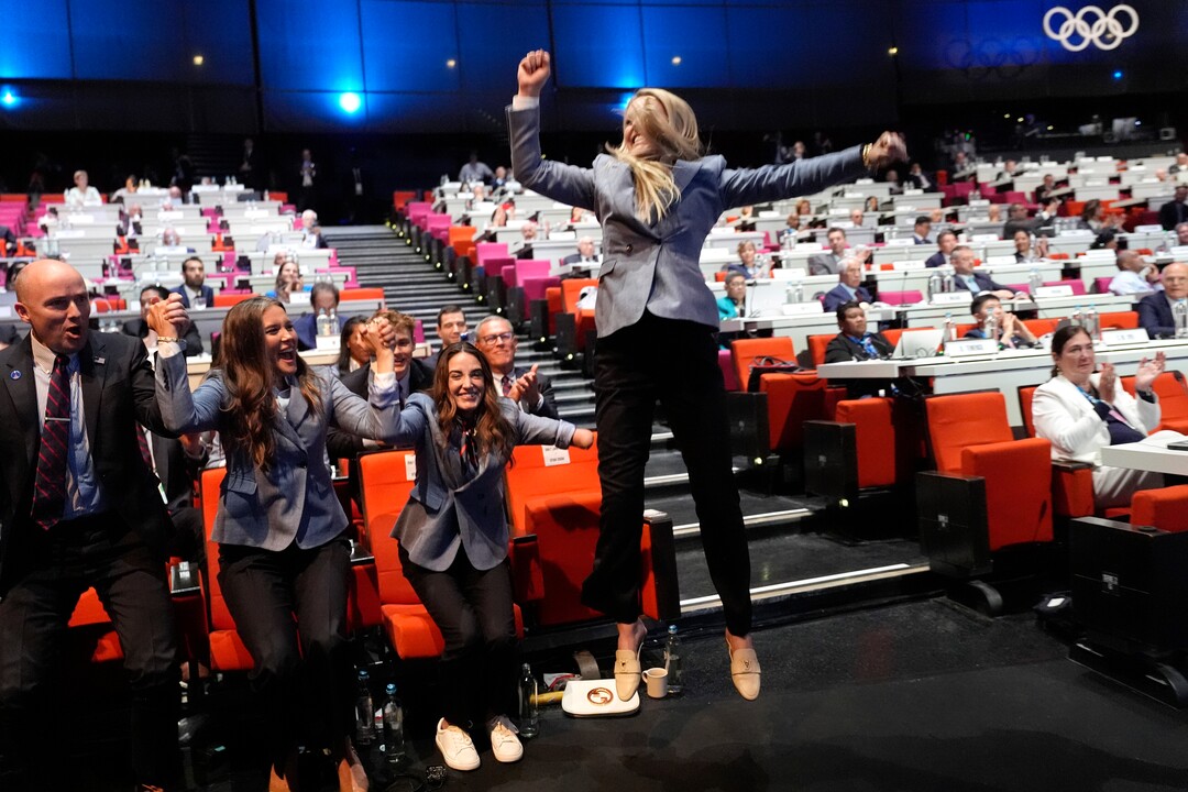 (David Goldman | AP) Former US skier Lindsey Vonn jumps after Salt Lake City was named Olympics host again as the IOC formally awarded the 2034 Winter Games to the United States bid, at the 2024 Summer Olympics, Wednesday, July 24, 2024, in Paris.