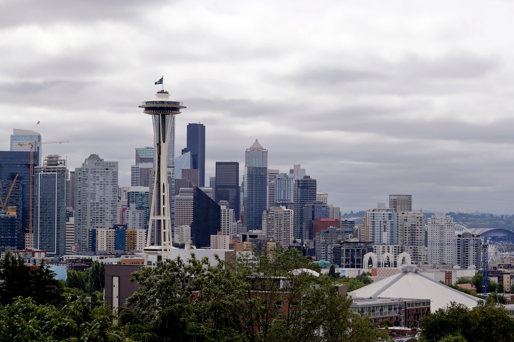 (Elaine Thompson | AP) The Seattle skyline is shown in 2020. The church is selling six meetinghouses in and around Seattle.