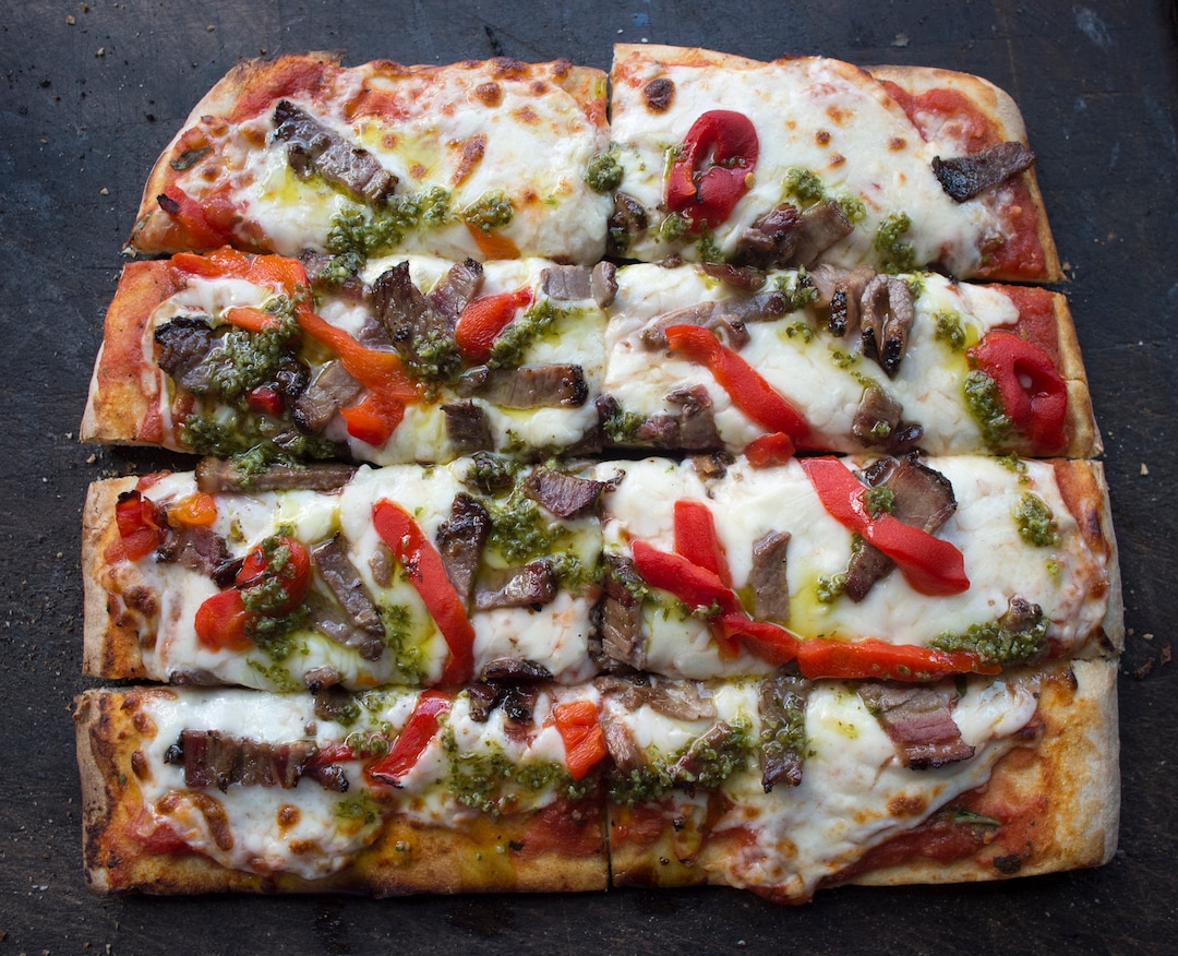 (Rick Egan  |  The Salt Lake Tribune) The Criolla pizza with smoked beef brisket, red peppers with homemade chimichurri from the Umani. The gourmet food truck serves square pizzas, similar to how it's done in Uruguay.