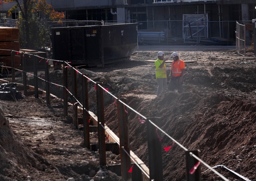 (Bethany Baker  |  The Salt Lake Tribune) Construction workers stand together at Atre Sugar House, a two-building development, in Salt Lake City on Friday, Nov. 10, 2023.