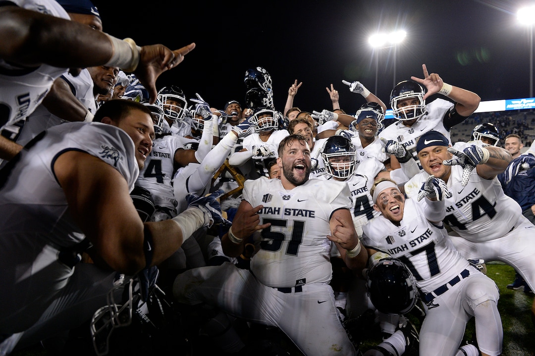 Leah Hogsten  |  The Salt Lake Tribune   Utah State Aggies celebrate the win after defeating BYU, 45-20, at Lavell Edwards Stadium in Provo, Friday, Oct. 5, 2018.