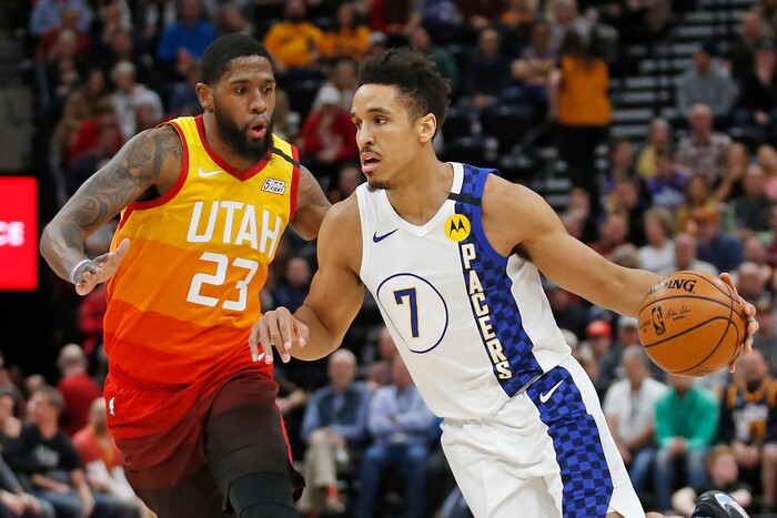 Indiana Pacers guard Malcolm Brogdon (7) drives around Utah Jazz forward Royce O'Neale (23) in the first half of an NBA basketball game Monday, Jan. 20, 2020, in Salt Lake City. (AP Photo/Rick Bowmer)