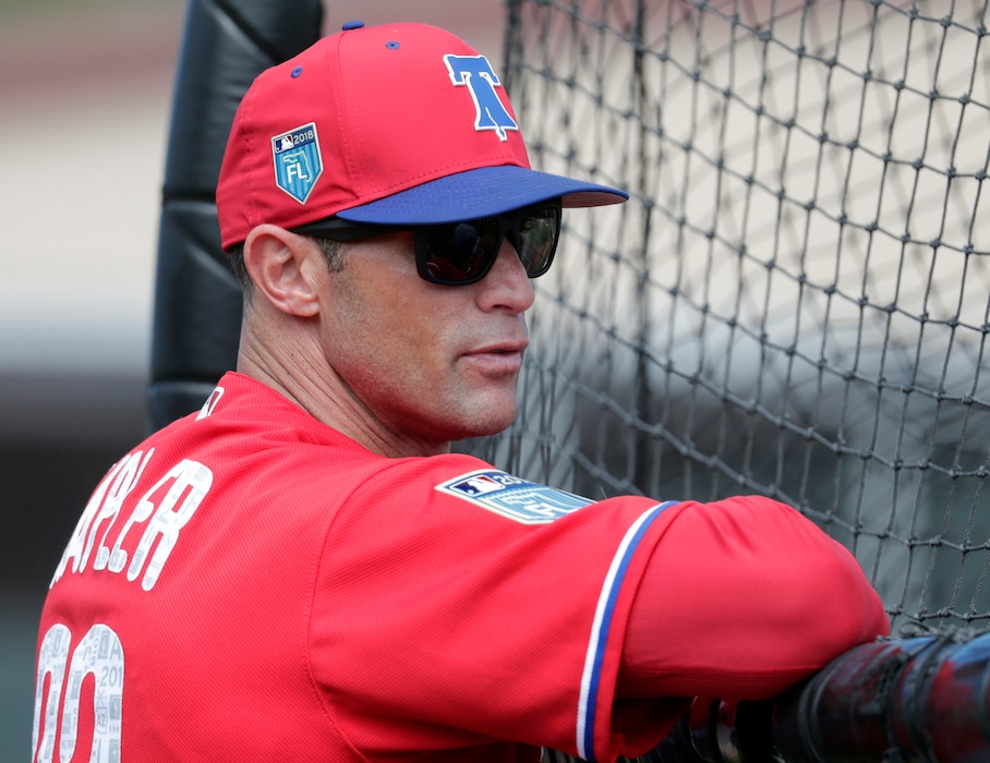 FILE - In this Feb. 20, 2018, file photo, Philadelphia Phillies manager Gabe Kapler watches batting practice at baseball spring training camp in Clearwater, Fla. Kapler has brought a new-school philosophy, a ton of energy and plenty of positivity to an organization that needed revitalization after five straight losing seasons.  (AP Photo/Lynne Sladky, File)