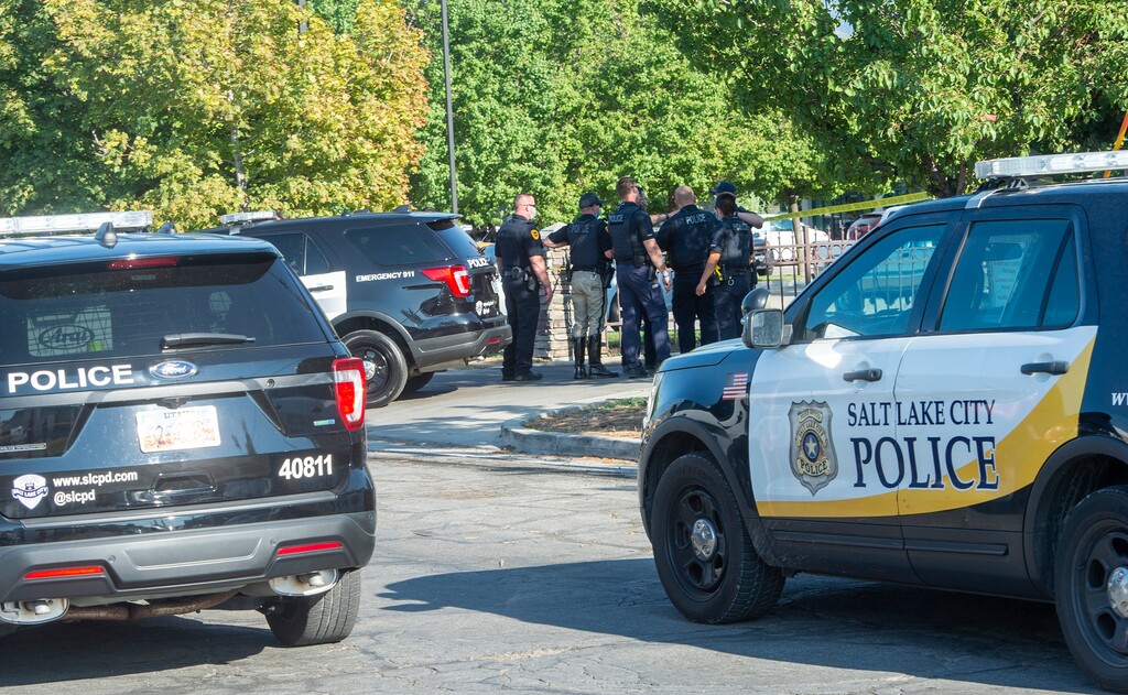 (Rick Egan  |  Tribune file photo)   Salt Lake City police officers stand near an apartment complex on Fayette Ave near Main Street and 965 South in Salt Lake City, where the police shot and killed a man they attempted to arrest for a parole violation, on Thursday, Aug. 27, 2020.