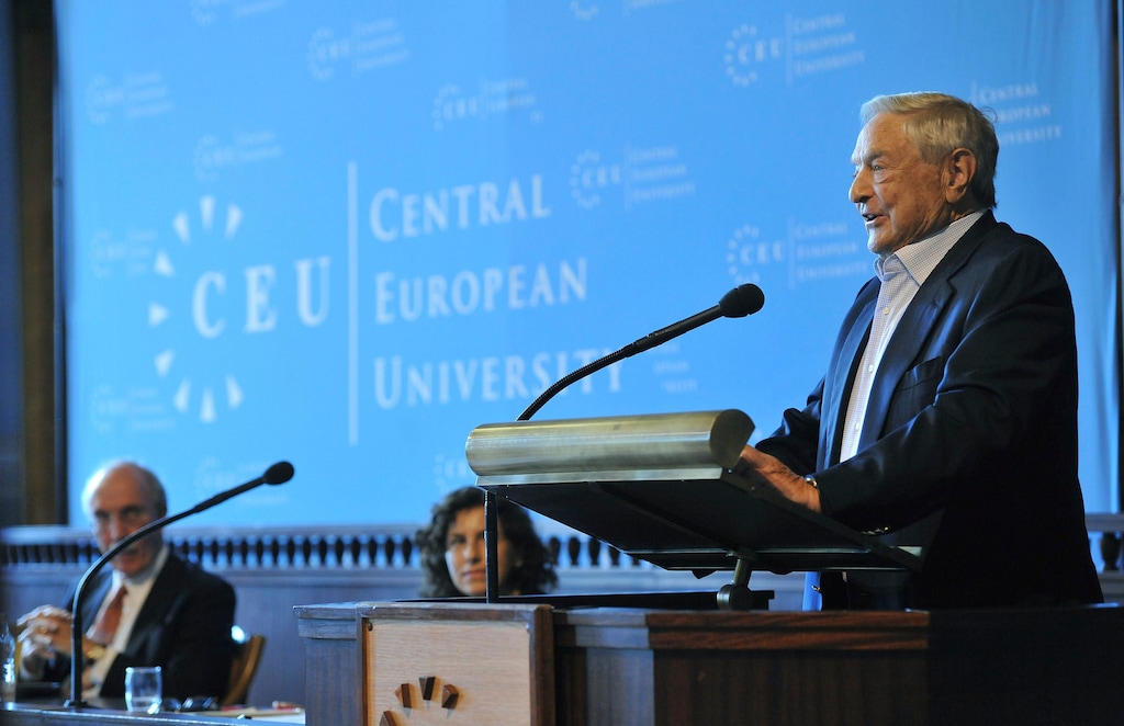 FILE - In this Sept. 14, 2012 file photo Hungarian born US billionaire philanthropist and Honorary Chairman of Board of Trustees of Central European University George Soros, right, speaks as President and Rector of CEU John Shattuck, left, and Pro-Rector Katalin Farkas, center, listen during the ceremonial opening of the new academic year of the university in the session hall of the Hungarian Academy of Sciences in Budapest, Hungary. Central European University is confirming that it will move its U.S.-accredited degree programs from the Hungarian capital of Budapest to Vienna from Sept. 2019, as Hungary's government is refusing to sign an agreement allowing it to stay. (Lajos Soos/MTI via AP, file)