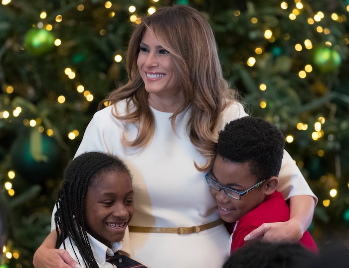 First lady Melania Trump is greeted by children as she arrives to visits with them in the East Room among the 2017 holiday decorations with the theme "Time-Honored Traditions" at the White House in Washington, Monday, Nov. 27, 2017. The First Lady honored 200 years of holiday traditions at the White House. (AP Photo/Carolyn Kaster)