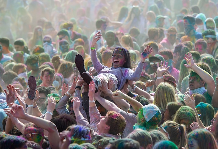 (Rick Egan  |  The Salt Lake Tribune)    Revelers help a friend crowd surf at the Holi Festival of Colors celebration at the Sri Sri Radha Krishna Temple in Spanish Fork, Saturday, March 30, 2019.


