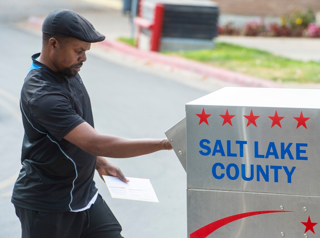 (Rick Egan  |  The Salt Lake Tribune)    A voter drops his ballot in the vote-by-mail ballot drop box at the Salt Lake County Government Center on Monday, Oct. 19, 2020.


