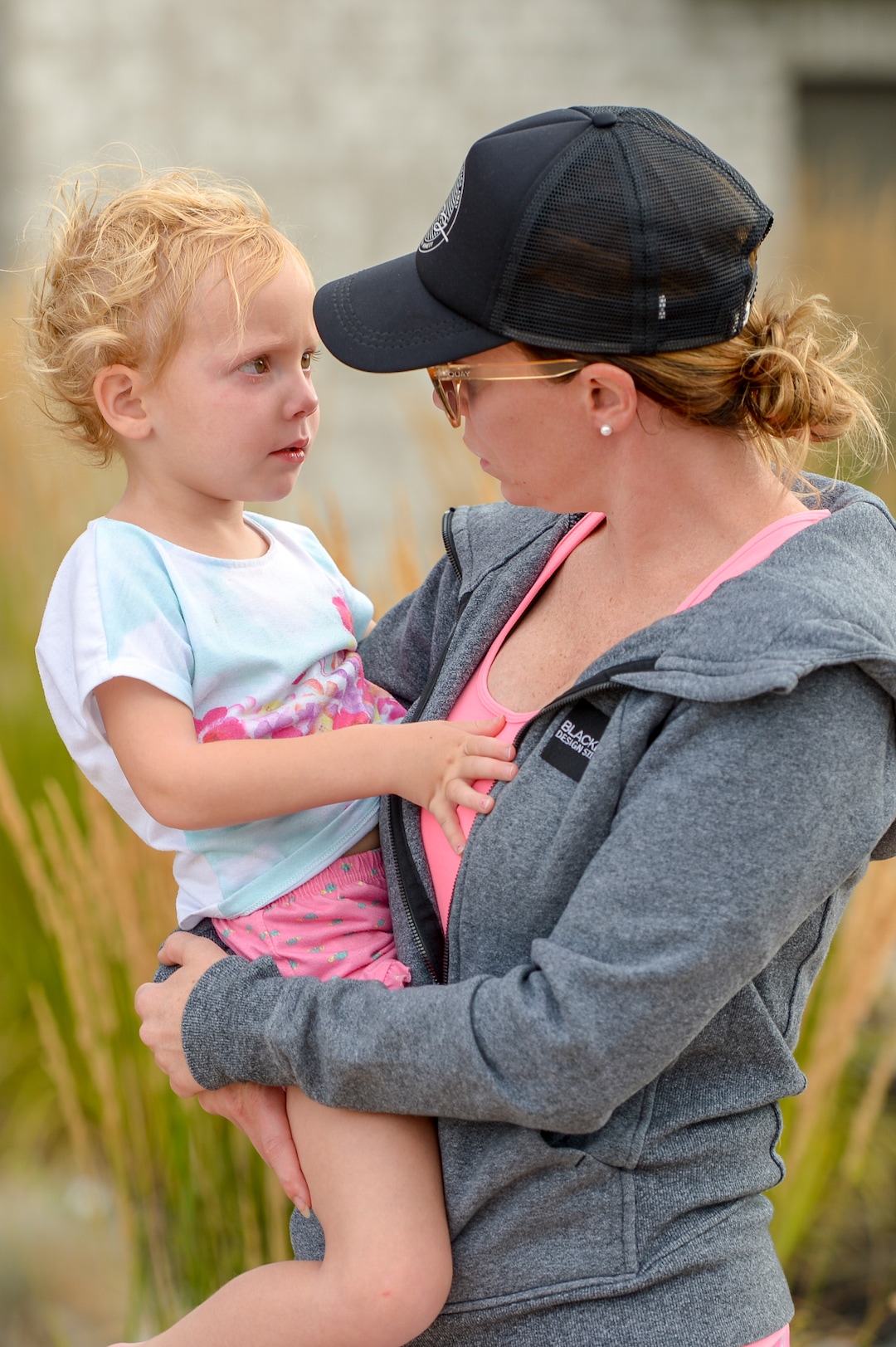 Leah Hogsten  |  The Salt Lake Tribune  Jenna Holt holds her upset 4-year-old daughter Monroe, who did not sleep Tuesday night for fear of the fire and was still visibly shaken Wednesday morning. Five people were injured and one home was damaged by a fast-moving grass fire on Columbus Court, Tuesday, July 24, 2018. Forty homes were evacuated as flames spread through about 100 acres. Between 50 and 60 firefighters responded to the fire.